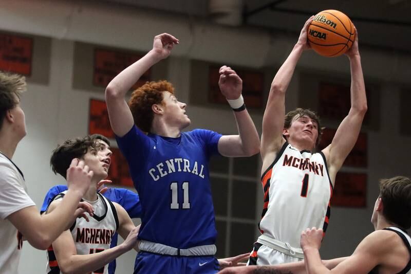 McHenry’s Dylan Hurckes, right, snags a rebound ahead of Burlington Central’s Patrick Shell, left, in varsity boys basketball on Tuesday, Feb. 4, 2025, at  McHenry High School  in McHenry.