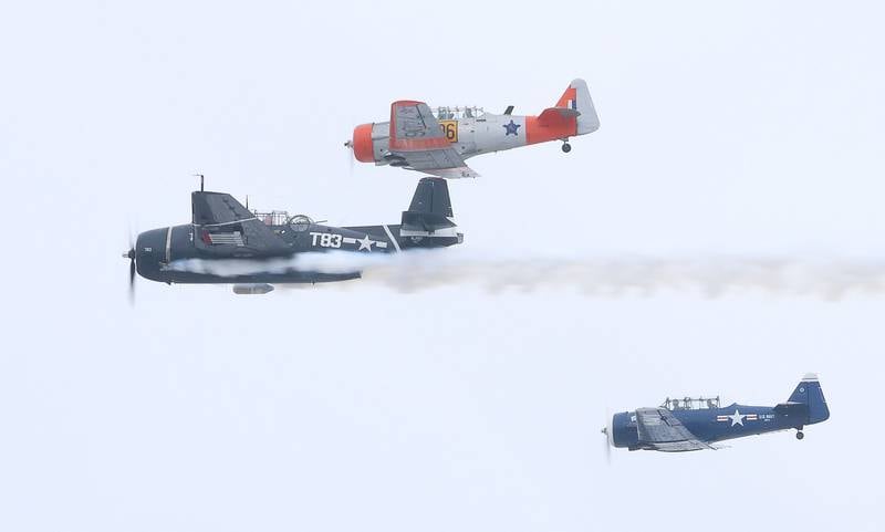A TBM and a pair of T-6 Texans fly over during the 46th annual Peal Harbor parade and Memorial service at the South Shore Boat Club in Peru.