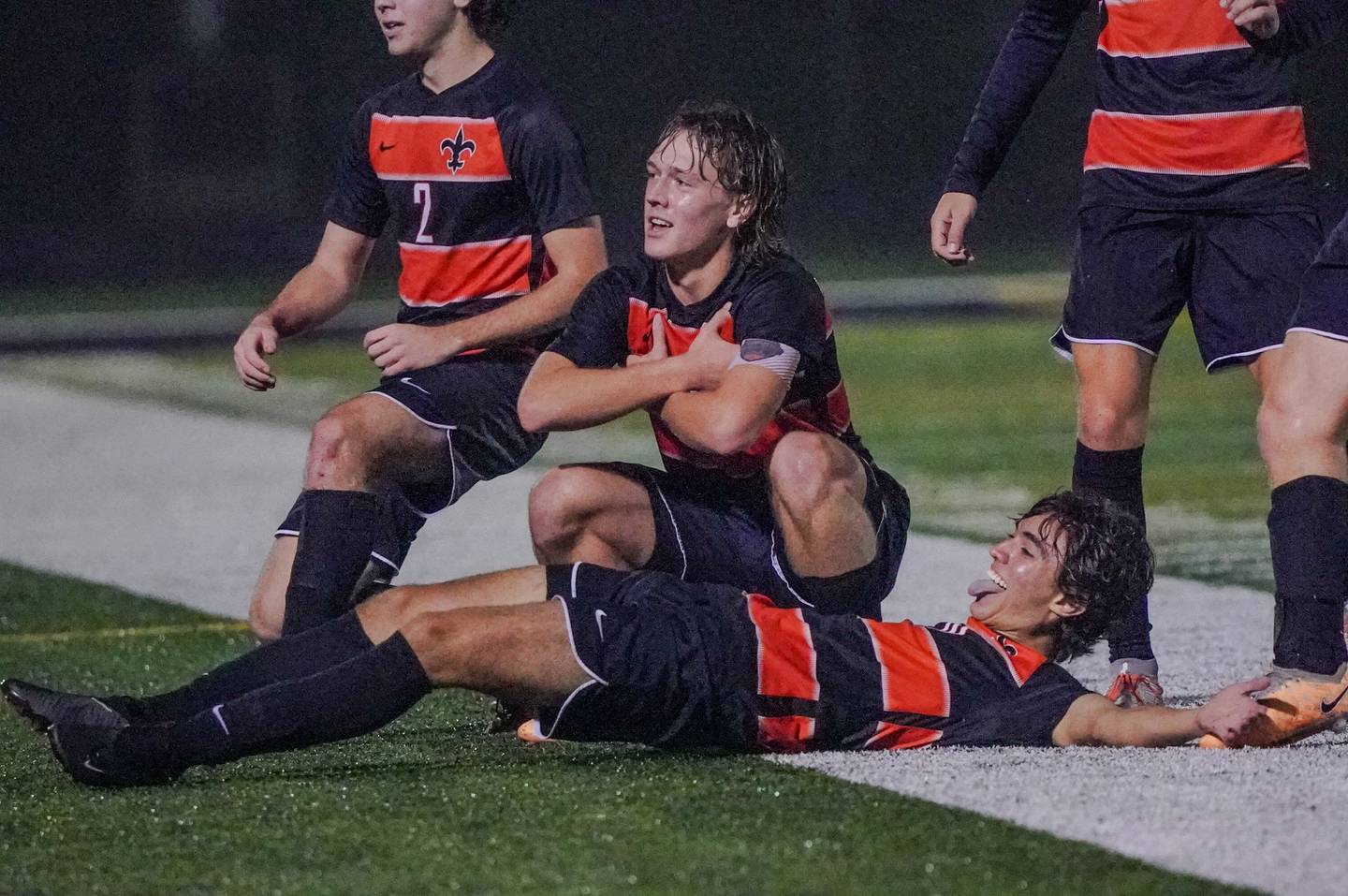 St. Charles East's Griffin Counts (middle) and Giuseppe Avendano (10) pose for the crowd after scoring a goal against West Chicago during a class 3A sectional semifinal soccer match at West Chicago High School on Wednesday, Oct. 25, 2023.
