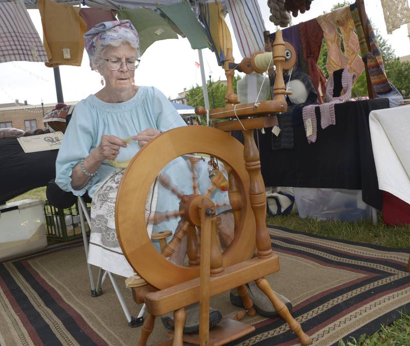 Margaret Jaeger of Ottawa demonstrates the art of spinning wool Saturday during the  annual Infinity Food & Art Festival in Ottawa.
