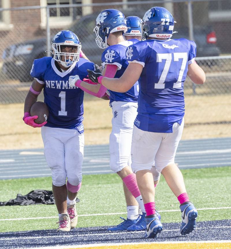 Newman’s Tyson Williams is congratulated by his team after scoring a touchdown against Mercer County Saturday, October 4, 2025.