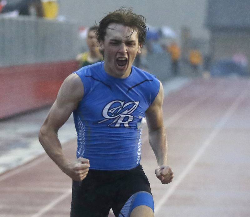 Burlington Central’s Nolan Milas celebrates winning the 400 meter run during the Fox Valley Conference Boys Track and Field Meet at Huntley High School.