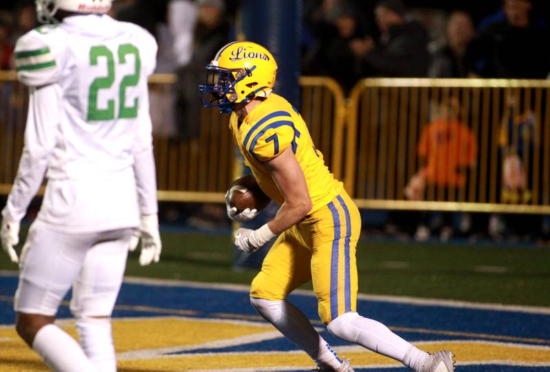 Lyons Township’s Jack McQueeney celebrates his touchdown during the Class 8A second round football playoff game against Yorkin Western Springs on Saturday, Nov. 4, 2023.