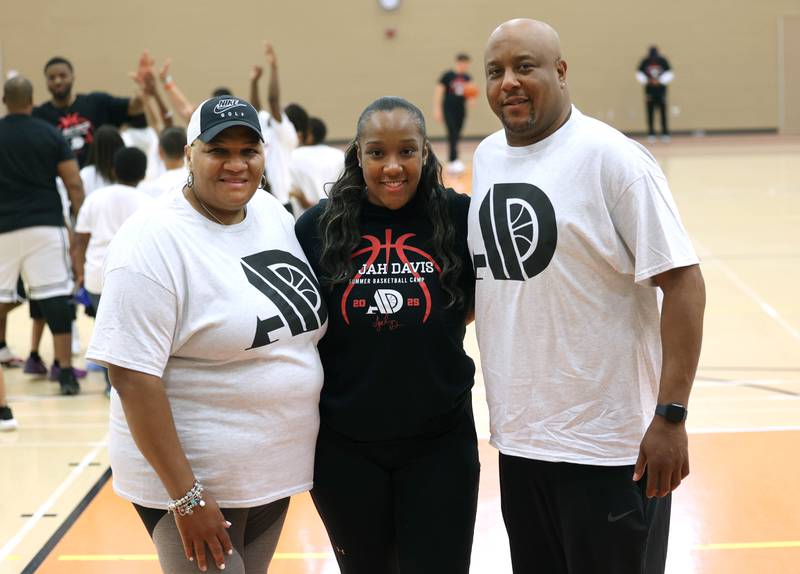 DeKalb native and former Northern Illinois University basketball player A'Jah Davis with her mom Herilanda Thigpen and dad Luke Davis Jr. Saturday, May 24, 2025, at her A'Jah Davis Foundation Basketball Camp and Wellness Day at DeKalb High School.