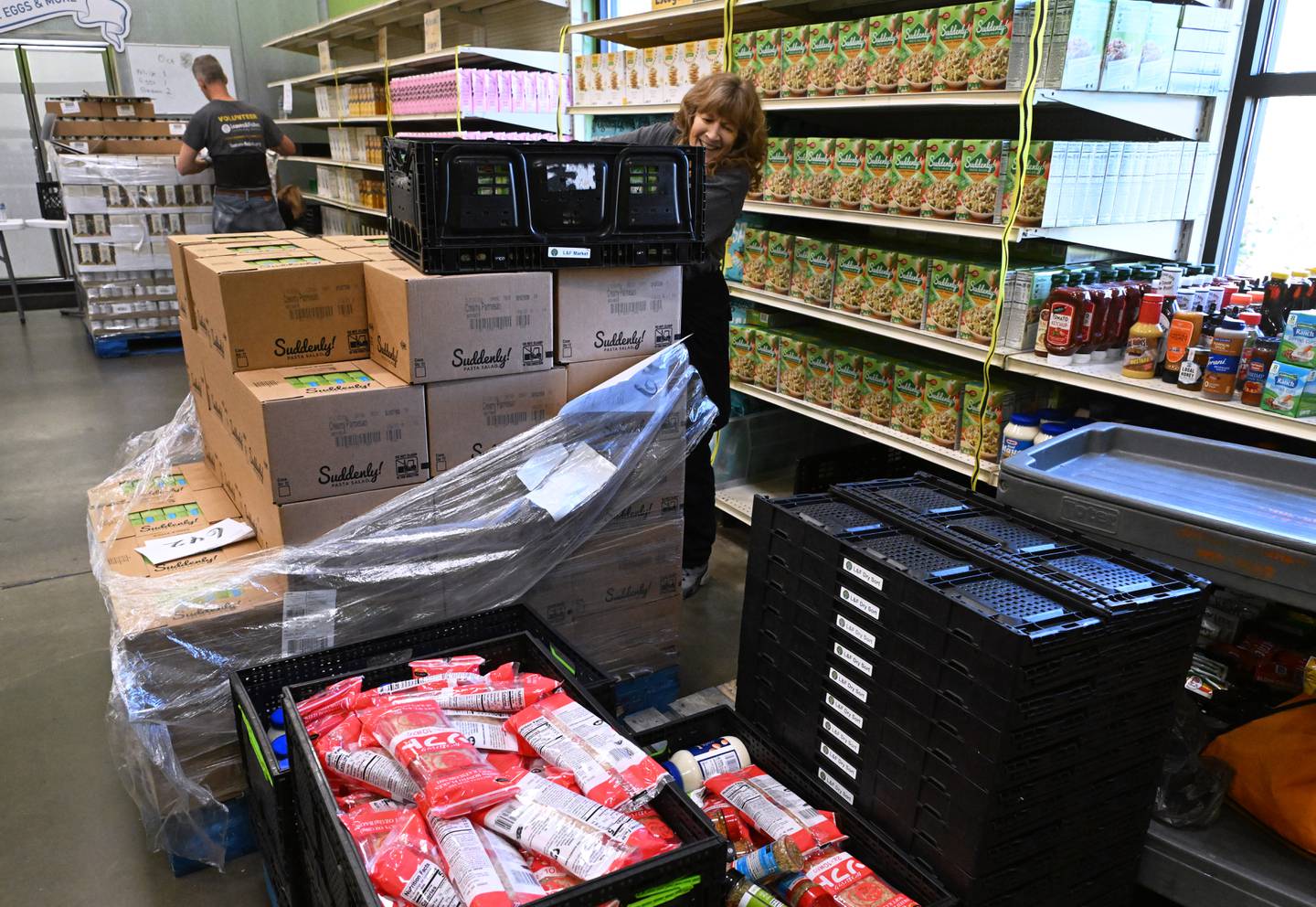 Volunteer Jean Lane unpacks food items at the Loaves & Fishes pantry in Naperville.