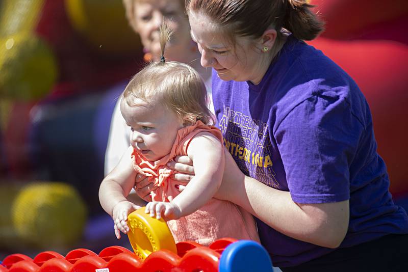 Charlie Meyers, 18 months, gets a boost from cousin Kaylee Ferguson Saturday, May 14, 2022 during the Sterling-Rock Falls Family YMCA’s Outdoor Adventure Fest. Held on the grounds of the Y, the festival opened up opportunities for families to explore healthy outdoor fun.
