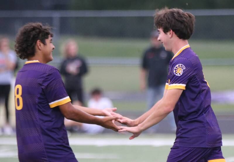 Mendota's Cameron Kelly hi-fives teammate Ramiro Palacios after scoring the teams third goal against Winnebago on Wednesday, Oct. 4, 2023 at Mendota High School.