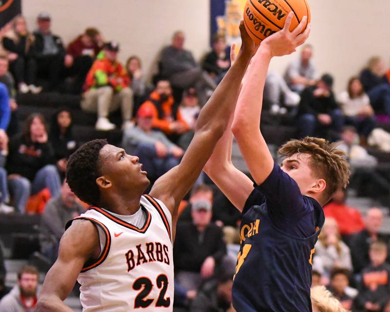 DeKalb's Justin O'Neal (22) blocks the shot of Neuqua Valley's Cole Kelly (23) on Saturday Dec. 28, 2024, during the 97th Chuck Dayton Classic Basketball championship game held at DeKalb High School.