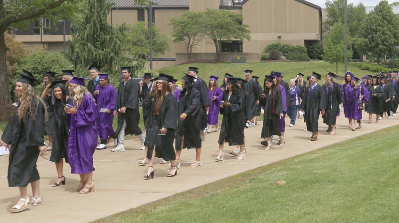 Illinois Valley Community College graduates walk in procession as they enter the gymnasium during the 59th annual Commencement Ceremony on Saturday, May 17, 2025 at IVCC.