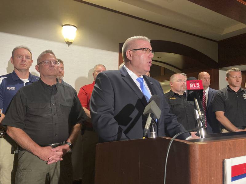 Illinois state Sen. Darren Bailey, the Republican nominee for governor, center, is joined by county sheriffs on Tuesday, Sept. 6, 2022. Bailey promised to restore the death penalty and repeal a wide-ranging criminal justice overhaul that will eliminate cash bail, following a Labor Day weekend that left multiple people dead in Chicago.  (AP Photo/John O’Connor)