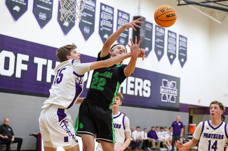 Bishop McNamara's Nolan Smith reaches for a rebound against Manteno's Colin Saathoff during the Fightin' Irish's 61-24 victory over Manteno on Tuesday, Jan. 13, 2026.