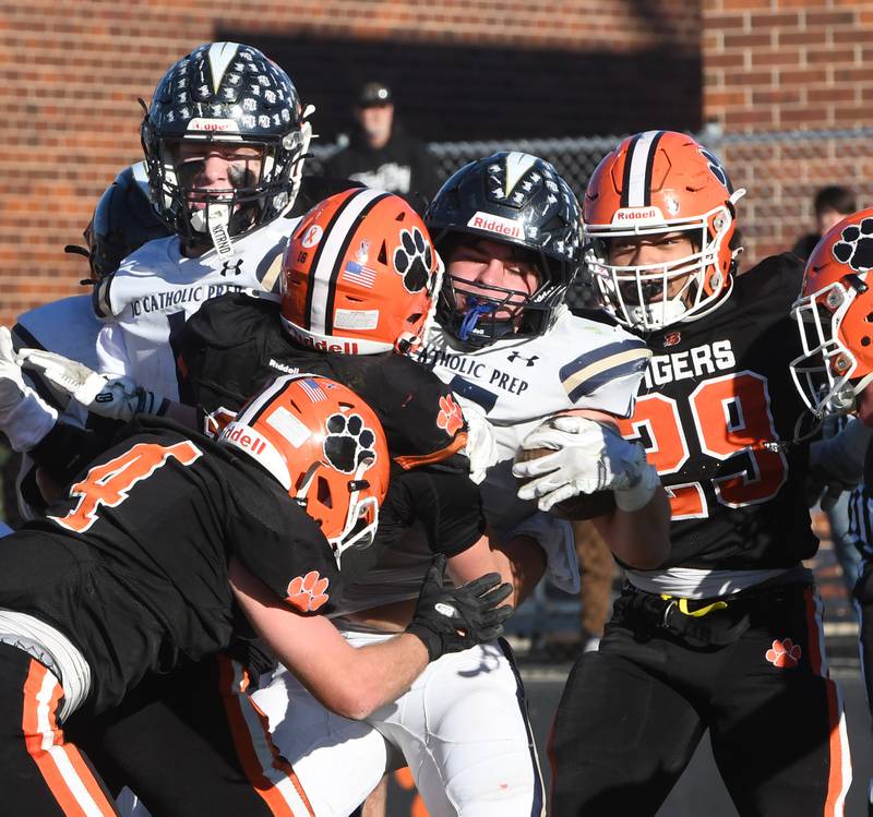 An Elmhurst IC Catholic player fights for yards against Byron during 3A quarterfinals at Byron High School on Saturday, Nov. 15, 2025.
