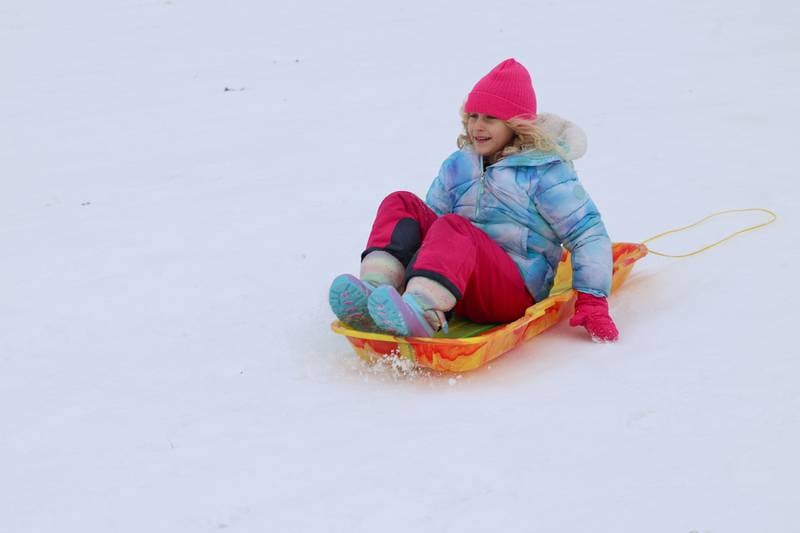 Vera Hazelrigg, 7, of Kankakee, sleds down the hill behind her brother, Coen, 5, at Helgeson Park in Bradley on Sunday, Nov. 30, 2025.