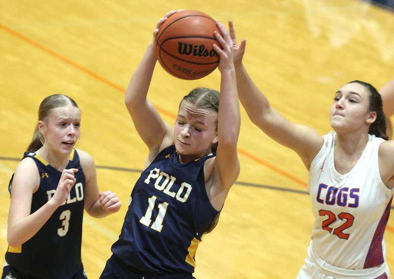 Polo's Courtney Grobe grabs a rebound in front of Genoa-Kingston's Regan Creadon during their game Monday, Jan. 29, 2024, at Genoa-Kingston High School.