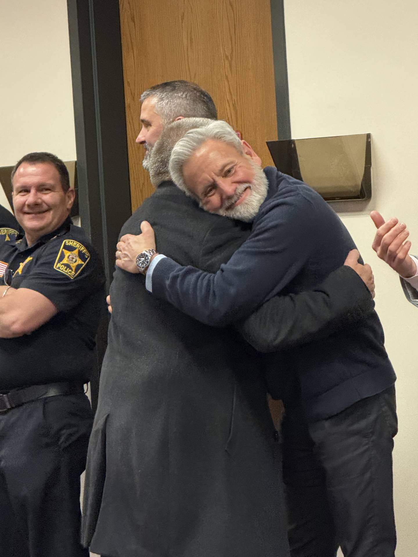McHenry County Judge Christopher Harmon hugs his friend Public Defender Mark Cook at Cook's surprise retirement party Jan. 30, 2026.