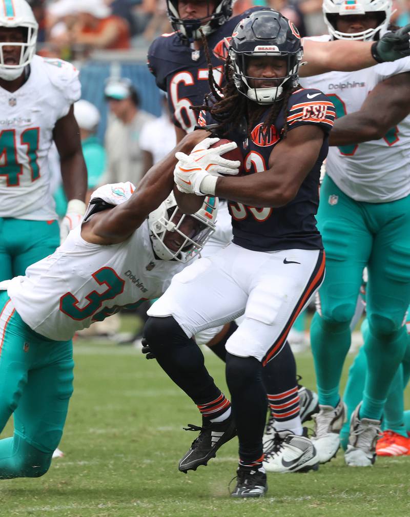 Chicago Bears running back Ian Wheeler breaks the tackle of Miami Dolphins cornerback Mike Hilton Sunday, Aug. 10, 2025, during their game at Soldier Field in Chicago.