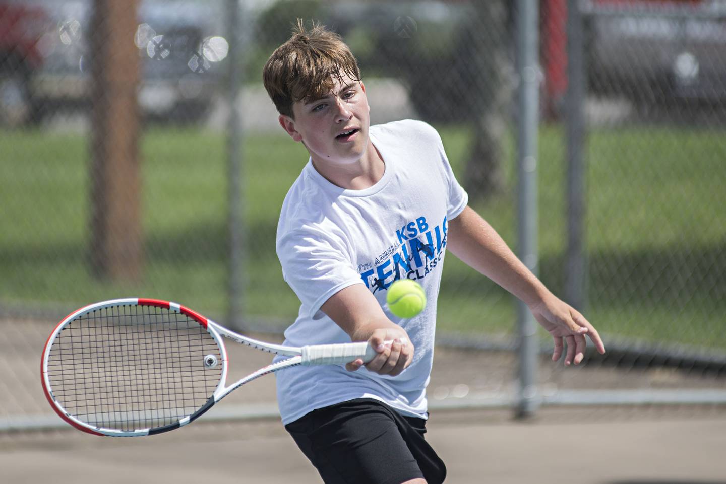 Owen Winters returns a shot while playing in the 15 and under boys single tournament during the Emma Hubbs tennis classic in Dixon.