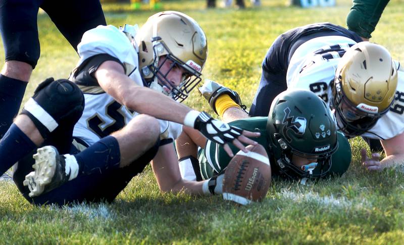 Polo's Ethan Dewey (52) reaches for the football as he recovers a fumble against West Carroll in 8-man football action in Mt. Carroll on Friday, Sept. 12, 2025.