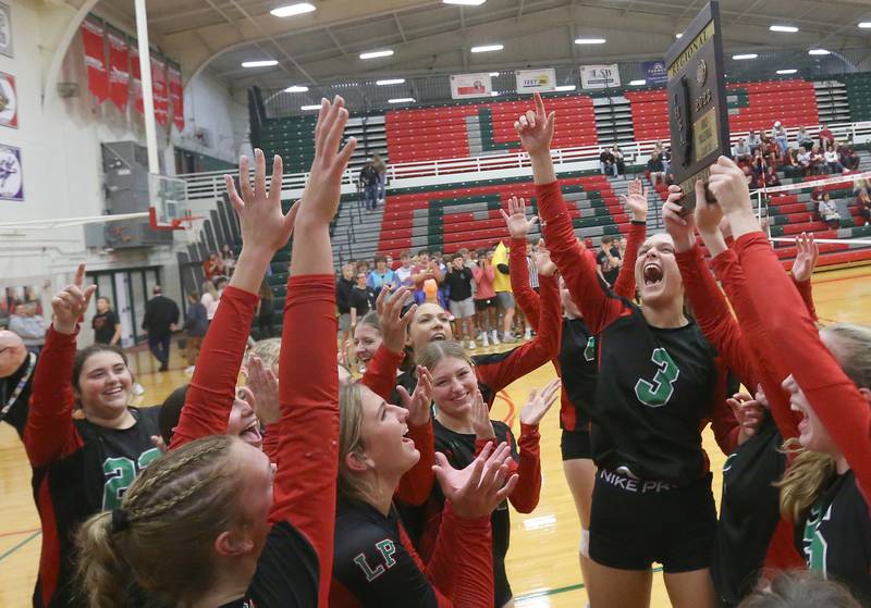 Members of the L-P volleyball team hoist the Class 3A Regional plaque after defeating Morris on Thursday, Oct. 26, 2023 at Sellett Gymnasium.