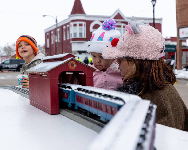 Olivia Coss watches on as the "Polar Express" toy train drives through tunnel on Saturday, December 6, 2025 on Illinois Avenue in Mendota.