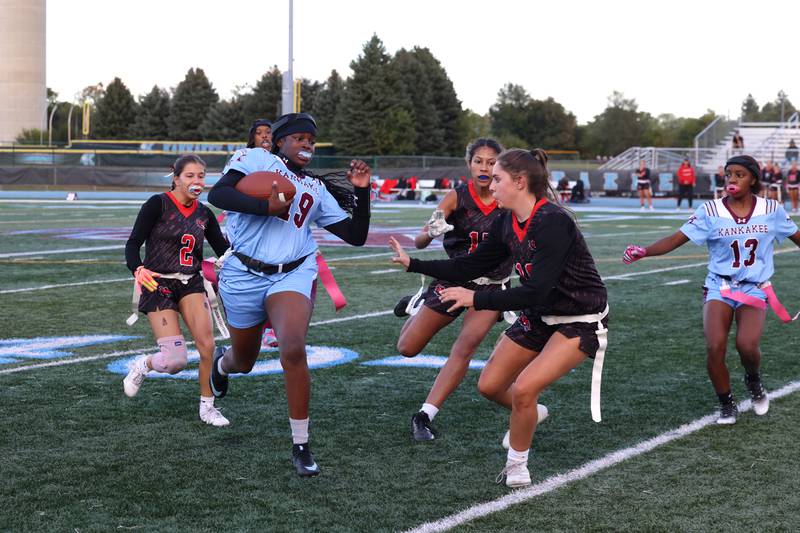 Kankakee's London Stroud runs the ball as Yorkville defenders close in during the Kays' 26-13 loss to Yorkville on Tuesday, Oct. 7, 2025.