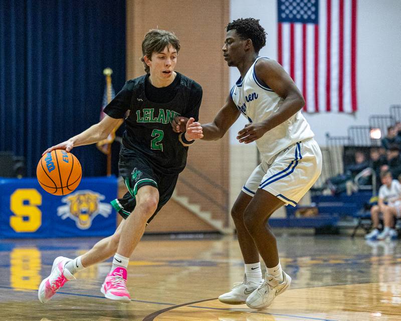 Hayden Spoonmore (2) of Leland drives ball down court whilst being guarded by Newark's Reggie Chapman (3) during the quarterfinals of the Little Ten Conference Tournament on Monday, Feb. 2, 2026 at Somonauk High School in Somonauk.