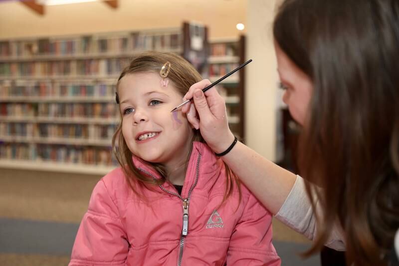 Six-year-old Aubree Schaeflein gets her face painted by Maggie Forgue at the Yorkville Public Library Mini Golf FUN Raiser on Sunday, Feb. 2, 2025 in Yorkville.