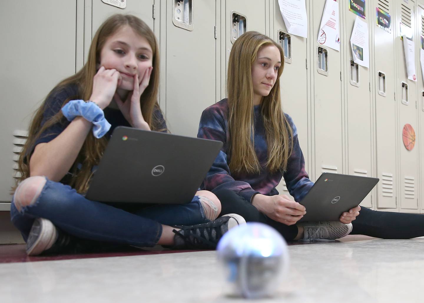 Wallace students Peyton Richards and Addison Diss, watch their light up ball dance around as the group programed it to dance to music at Wallace Grade School on Thursday, April 7, 2022 in Wallace.