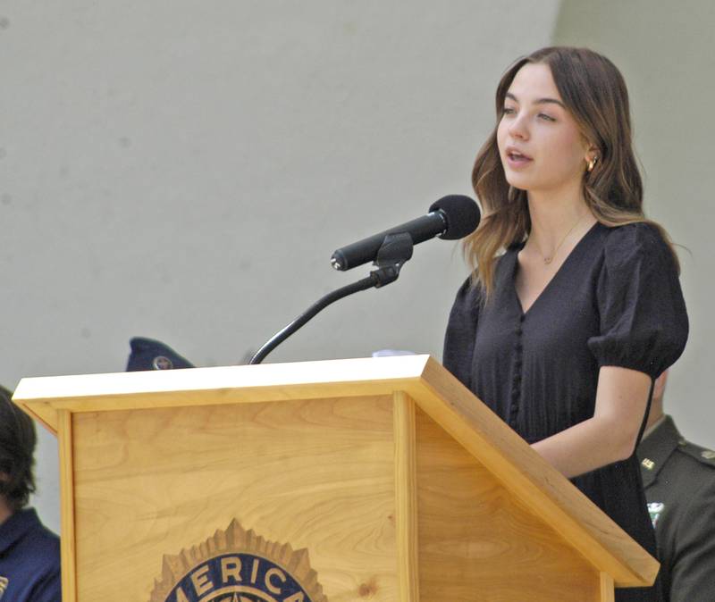 Sterling High School Junior Avery Moran reads "General Logan's Order," which created Memorial Day, during Sterling American Legion Post's commemoration Monday, May 26, at Grandon Civic Center in Sterling.