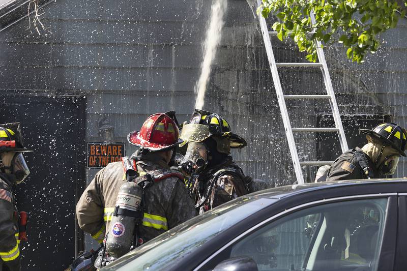 Firefighters work at the scene of a house fire at 204 East 11th Street in Rock Falls Wednesday, May 1, 2024.