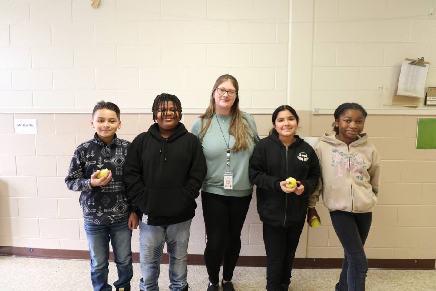 Woodland Elementary fourth-grade teacher Chelsea Young (center) was recently named a 2023 Golden Apple Awards for Excellence in Teaching finalist. Her students received golden delicious apples so they could celebrate with her. Pictured with her, from left, Daniel Sandoval, Juan Moffet. Monserrat Avalos-Ayala and Naomi Awinongya.