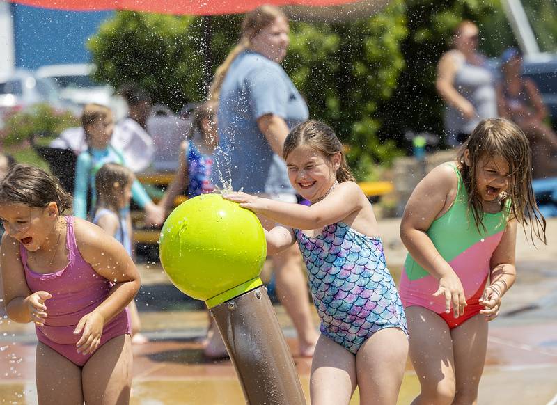 Brylynn Kruse (left), 8, Maesyn Cavazos, 7, and Bristyl Kruse, 6, play with a water feature Wednesday, June 11, 2025, at Water Wonderland in Dixon.