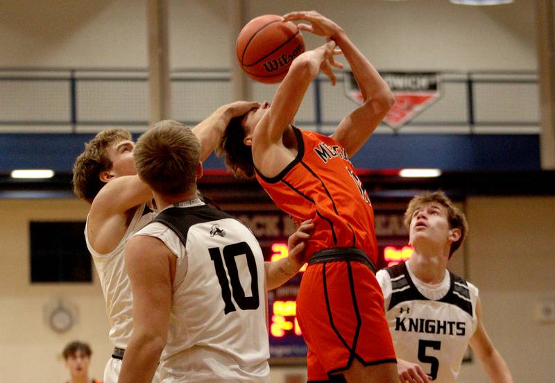 McHenry’s Caleb Jett is fouled against Kaneland in Hoops for Healing basketball tournament championship game action at Woodstock Wednesday.