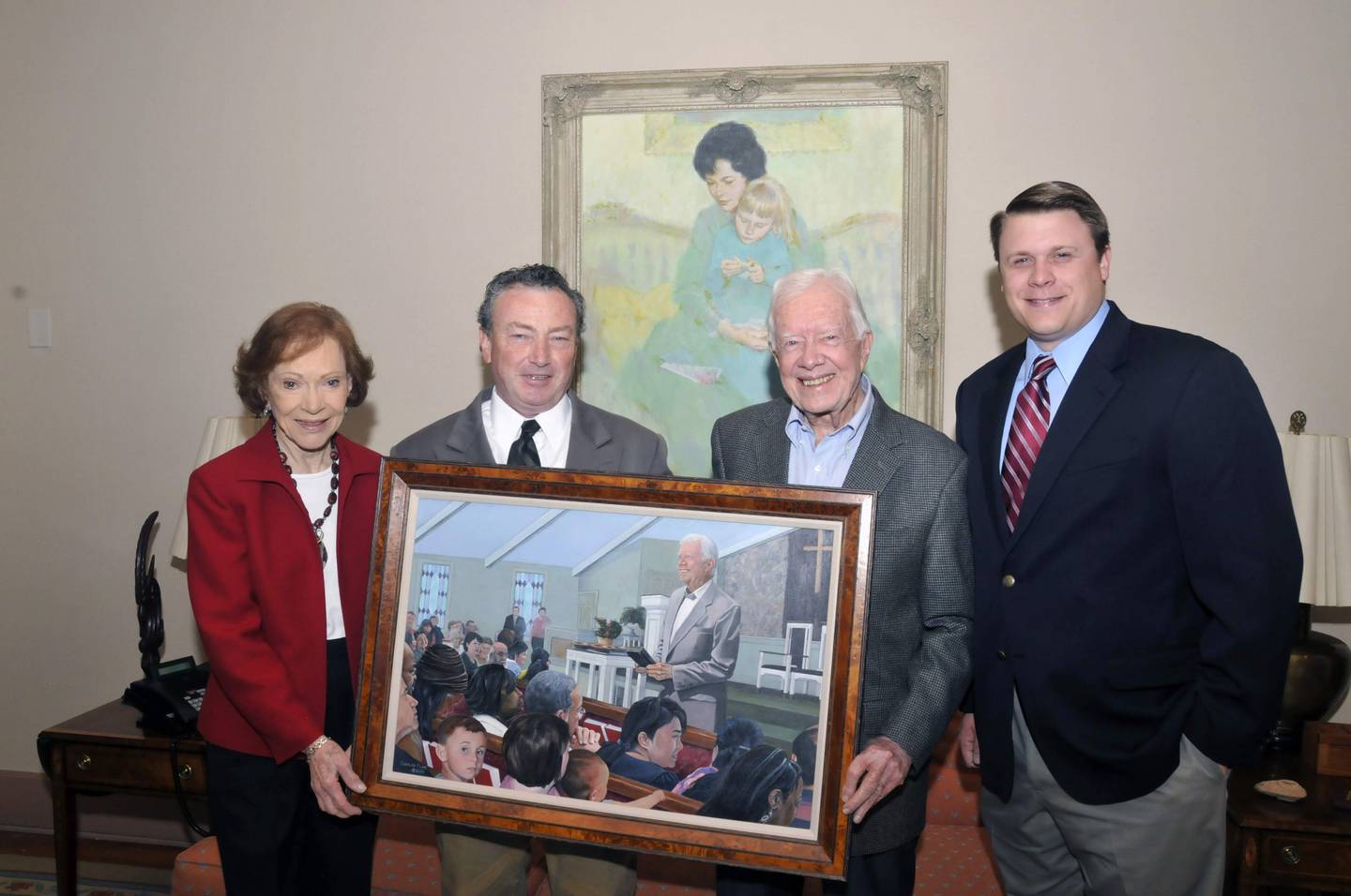 Chuck Funk (second from left) poses with former First Lady Rosalynn Carter, former President Jimmy Carter and Voice of America correspondent Kane Farabaugh in 2012 with Funk's painting of Jimmy Carter teaching Sunday School at Maranatha Baptist Church in Plains. Farabaugh's family is in the lower left in the pew in the painting as a special nod from Funk. His eldest son Lucas Farabaugh is looking at the viewer of the painting.
