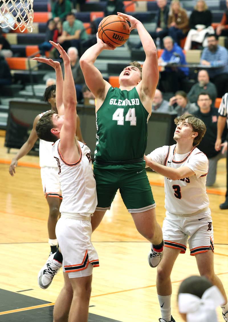 Glenbard West's Jack Oberhofer shoots between two DeKalb defenders during their game Tuesday, Nov. 29, 2022, at DeKalb High School.
