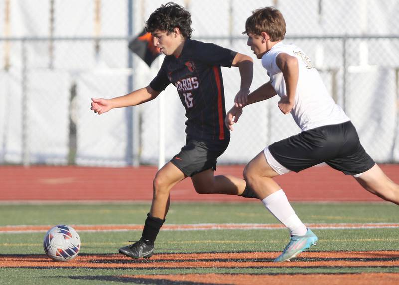 DeKalb's Aaron Tierney and Sycamore's Carter England go after the ball during their game Tuesday, Oct. 4, 2022, at DeKalb High School.