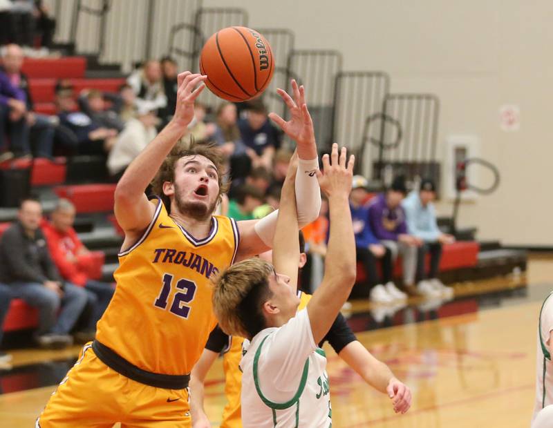 Mendota's Braiden Freeman grabs a rebound over Rock Fall's Austin Castaneda during the 49th annual Colmone Classic on Friday, Dec. 8, 2023 at Hall High School.