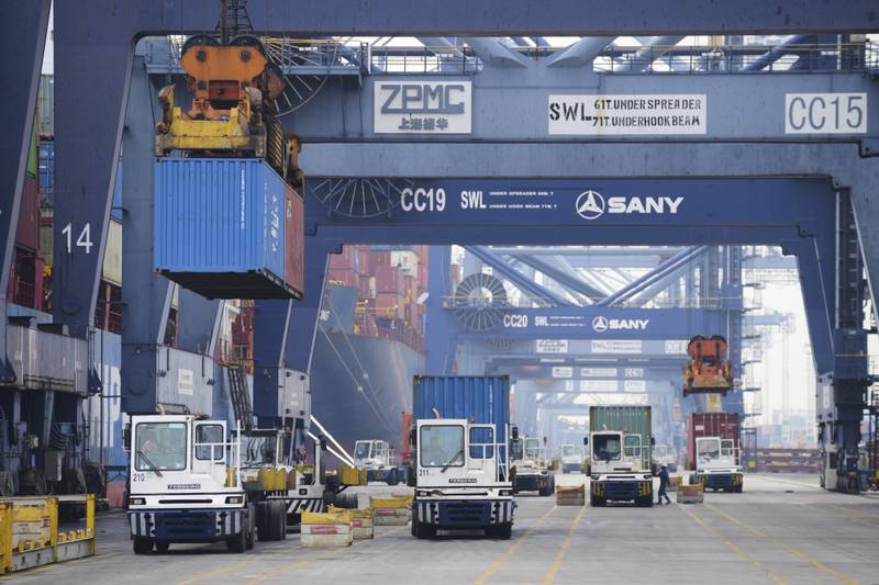 Cranes unload shipping containers from trucks at Jakarta International Container Terminal (JICT) at Tanjung Priok Port in Jakarta, Indonesia, Wednesday, July 9, 2025. (AP Photo/Tatan Syuflana)