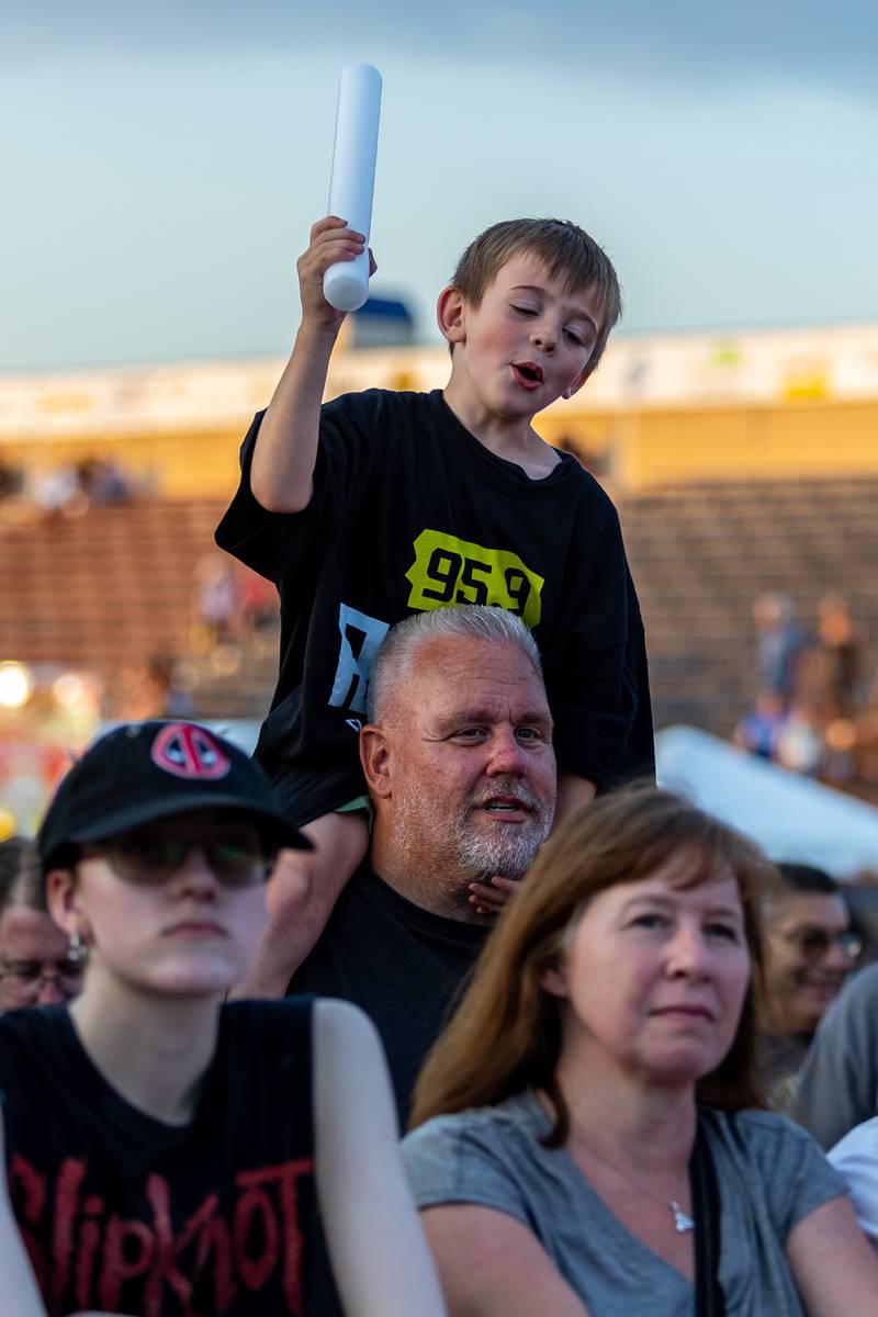 Joliet residents Brian Bessler and Brian Bessler, Jr. rock out to the music of Return to Dust during Taste of Joliet on June 20, 2025.