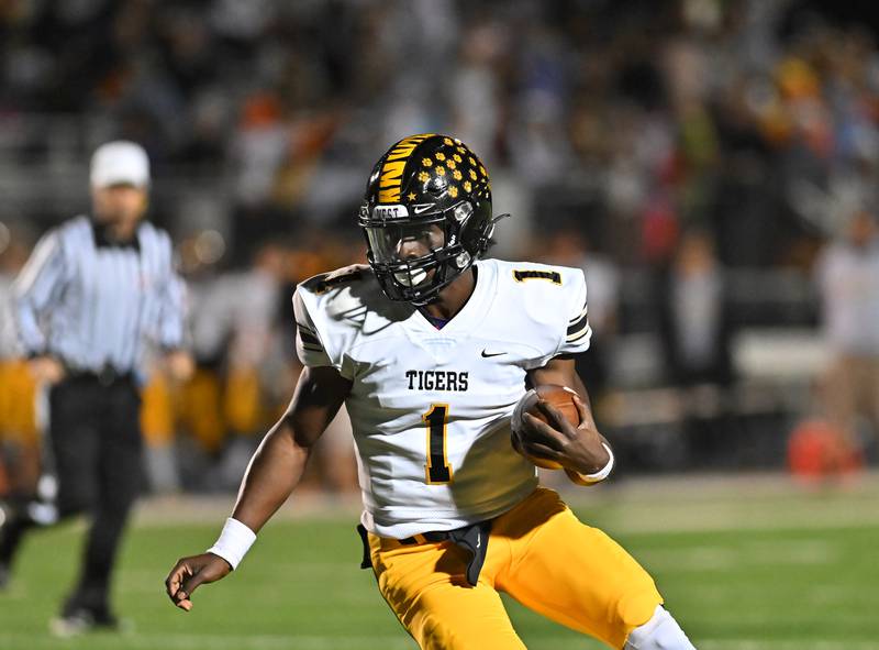 Joliet West's Carl Bew (1) tries to pick up a first down against Plainfield South on Friday, Oct. 21, 2022, at Plainfield. (Dean Reid for Shaw Media)