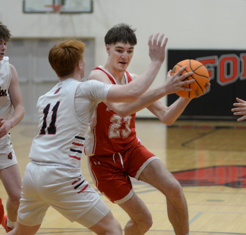 Morrison's Asher Ernst (23) makes a move to the basket as Forreston's Connor Politsch (11) defends during a Saturday, Feb. 8, 2025 game at Forreston High School. The Cardinals won the game 70-49.
