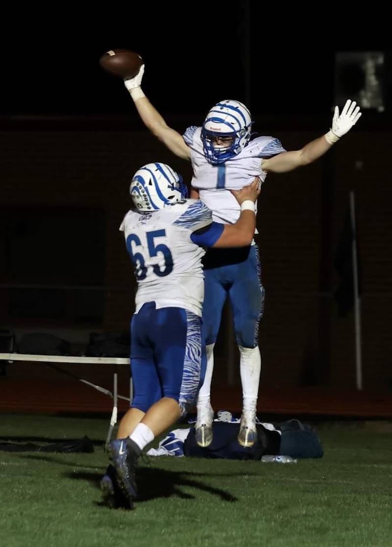 Princeton's Casey Etheridge gets a lift from teammate Cade Odell after scoring a touchdown in Friday's game at Prophetstown. The Tigers won 61-14.
