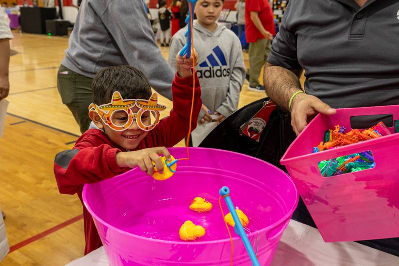 Joel Castro fishes for rubber ducks on Friday, May 2, 2025 at Northbrook School in Mendota.