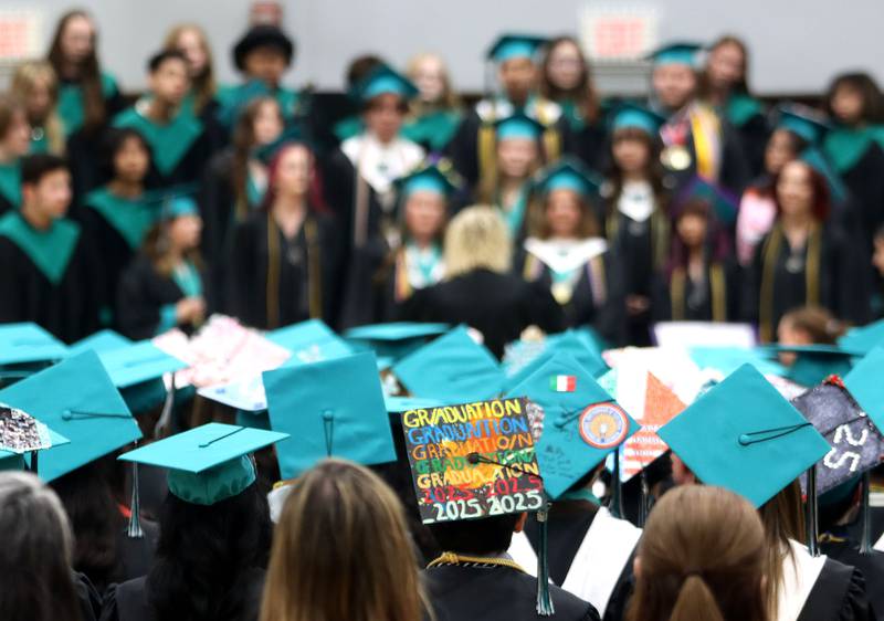 Members of the Class of 2025 listen as the choir performs “Somewhere Only We Know” during graduation at Woodstock North High School in Woodstock on Saturday, May 17, 2025.