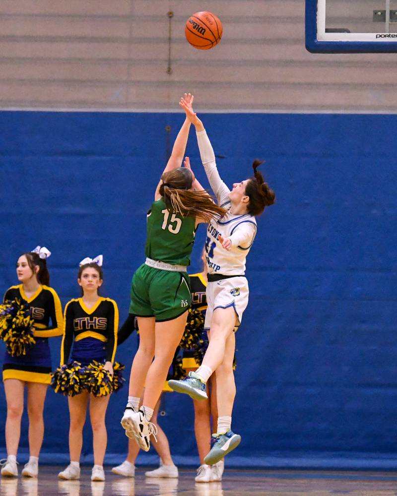 Lyons Township Ally Cesarini, right, defends York Allison Sheehan (15) as she makes a basket during the second quarter Friday Feb. 3rd during a home game held at Lyons Township High School.