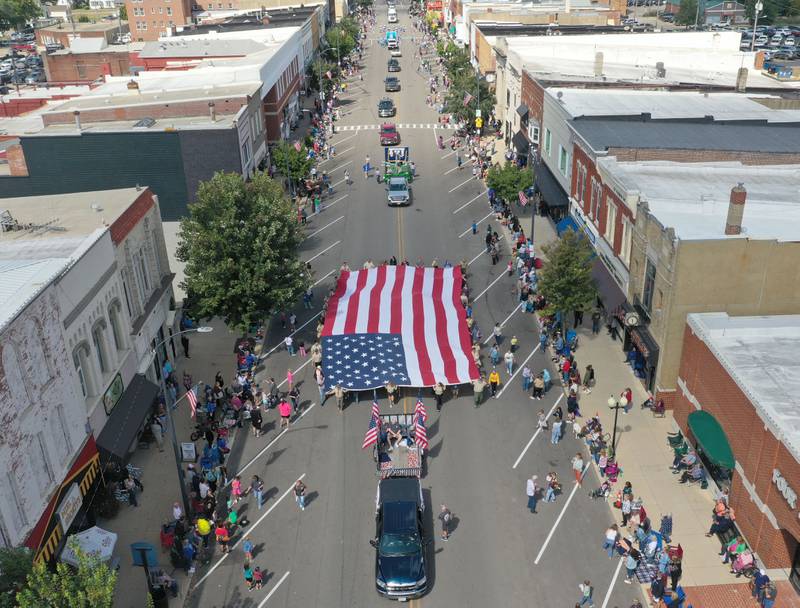 An aerial view of the giant American flag as it is carried down South Main Street during the 54th annual Homestead Festival parade on Saturday, Sept. 6, 2025 in Princeton.