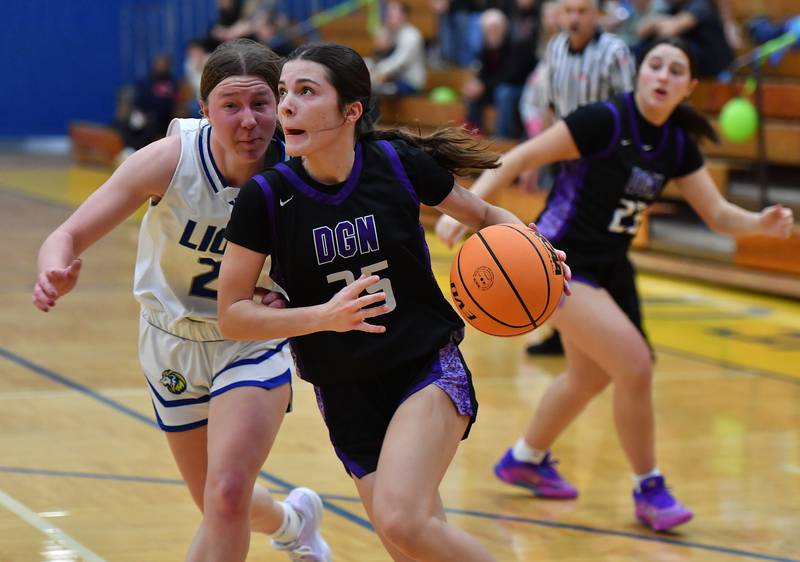 Downers Grove North’s Caitlin Sandridge drives the baseline as Lyons Township’s Anna Bigenwald defends during a game on January 10, 2026 at Lyons Township High School in LaGrange.