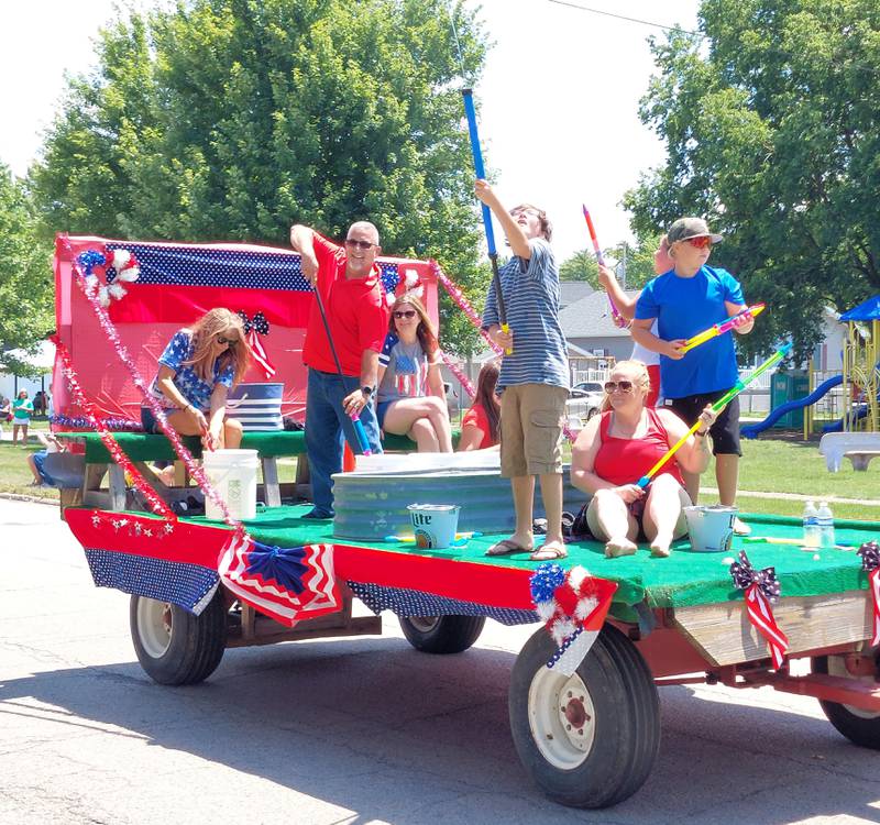 Parade goers were cooled down with water Sunday, July 9, 2023, along the Marseilles Fun Days parade route.