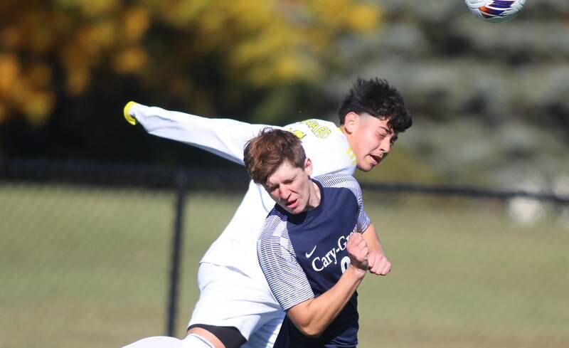 Cary-Grove’s  Daniel Czerwinski, front, battles Harvard’s Jonathan Roldan for the ball in IHSA Class 2A Regional Title Game soccer action on Saturday, Oct. 26, 2024, at  Harvard Junior High School  in Harvard.
