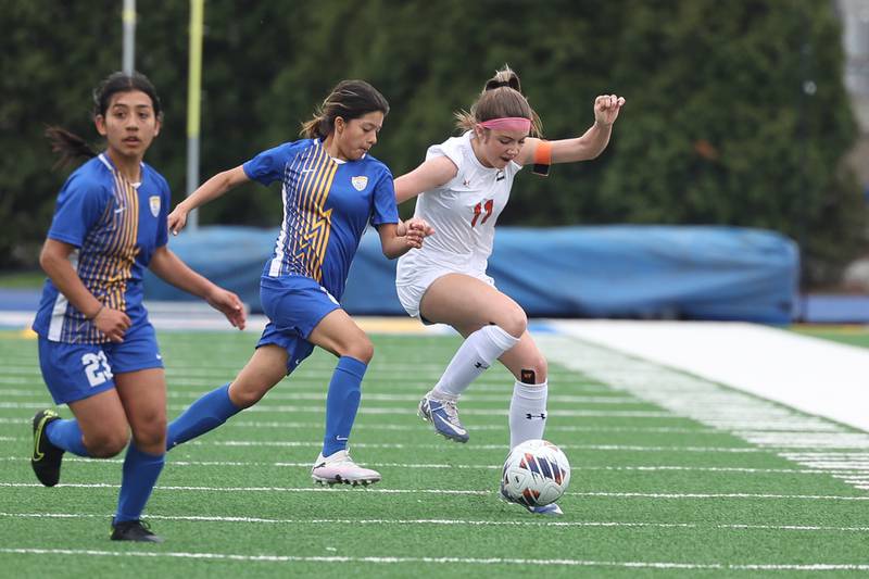 Plainfield East’s Caroline Dinnon works the ball against Joliet Central’s Ariadna Arciniega on Thursday, April 11, 2024.